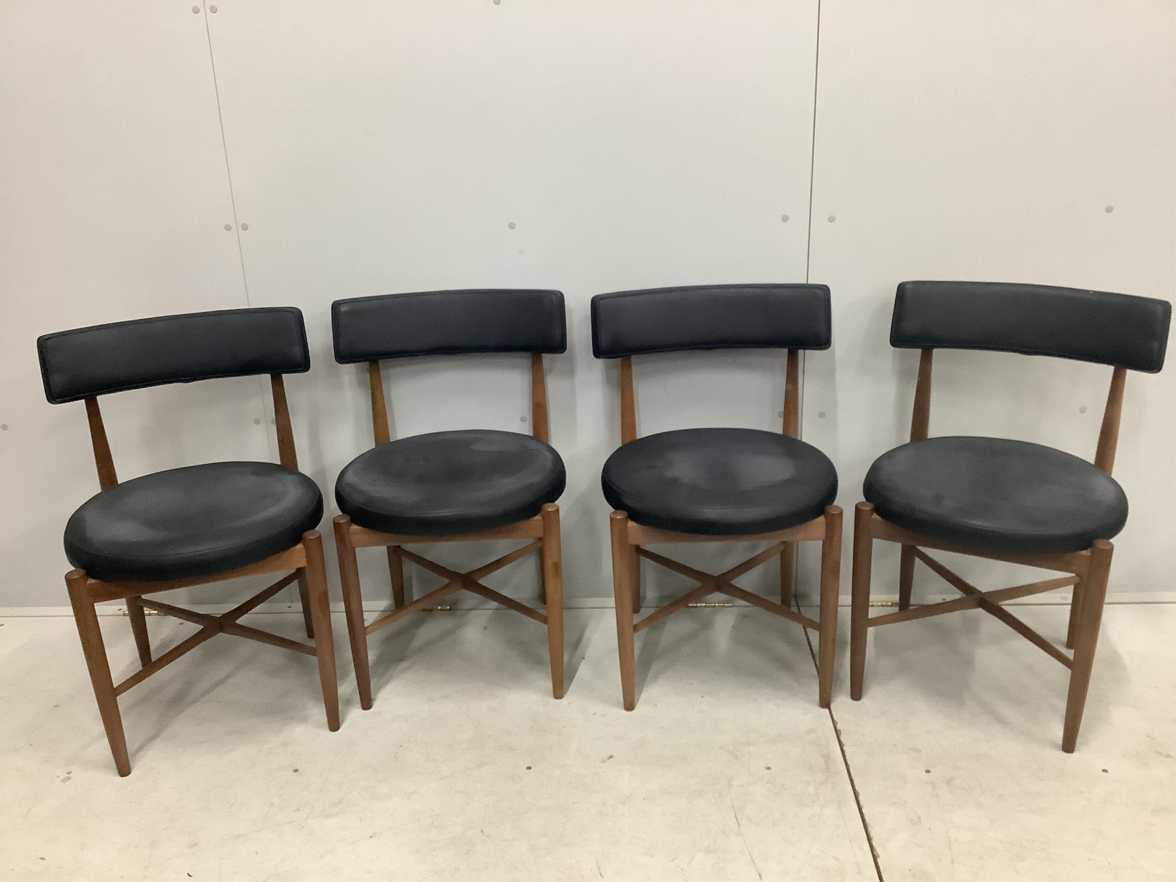 A mid century G Plan teak extending dining table, 158cm extended, depth 112cm, height 72cm and four chairs. Condition - fair to good